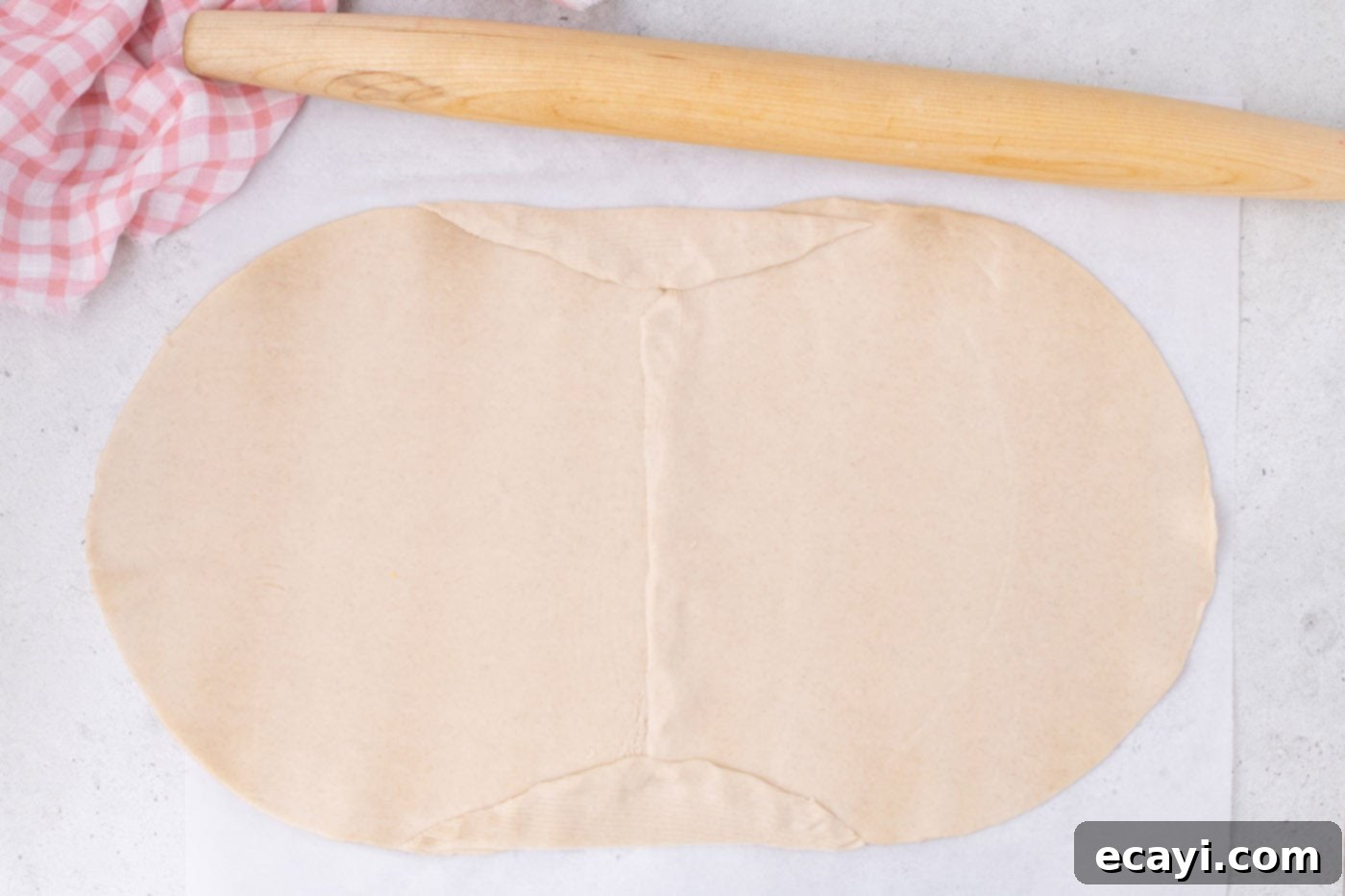 Strawberry Sheet Pan Delight 8 joining two pie crusts together with a rolling pin to form a larger sheet