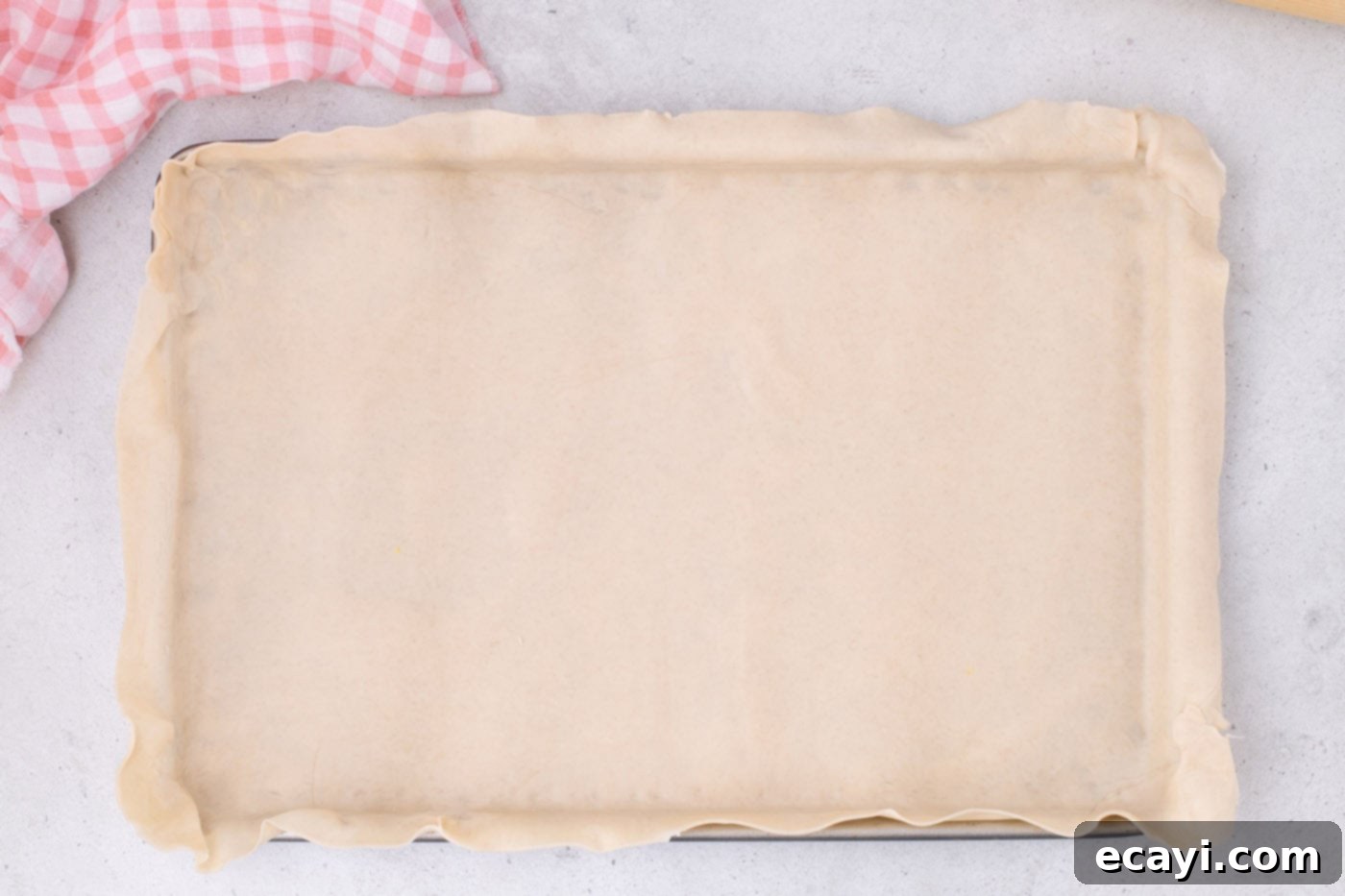Strawberry Sheet Pan Delight 10 pie crust perfectly placed in a jelly roll pan, ready for filling