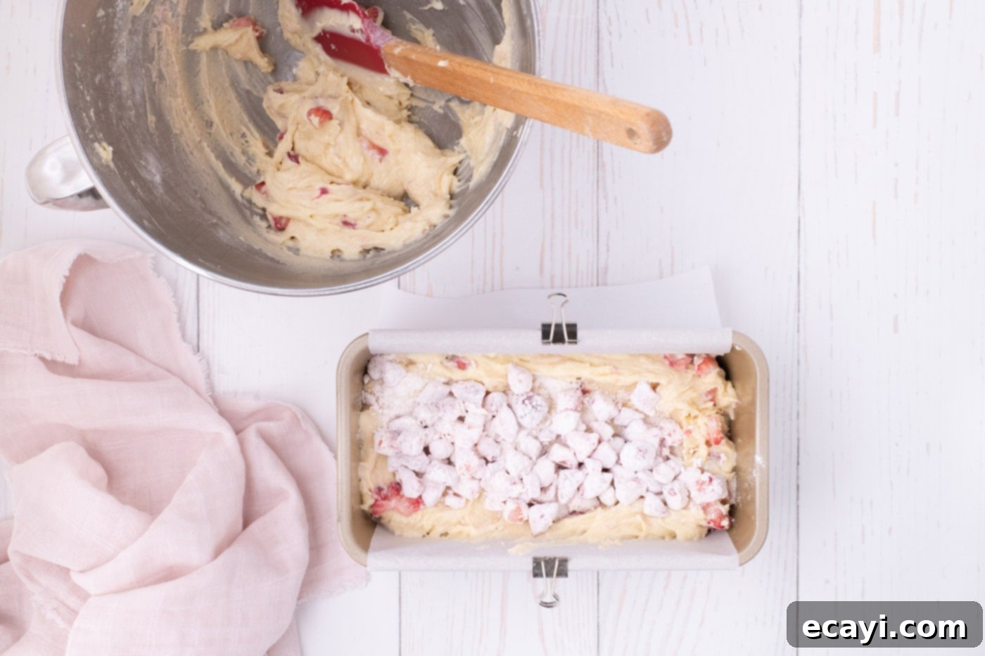 Luscious Strawberry Pound Cake 11 Three-quarters of the strawberry pound cake batter in a loaf pan, topped with a generous sprinkle of the remaining flour-coated strawberries.