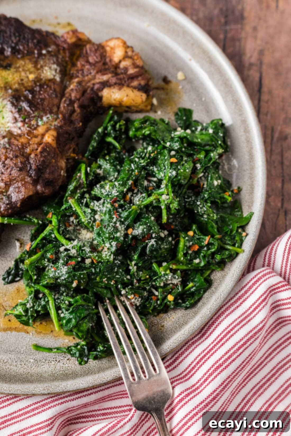Air Fryer Spinach on a plate with a fork to the side