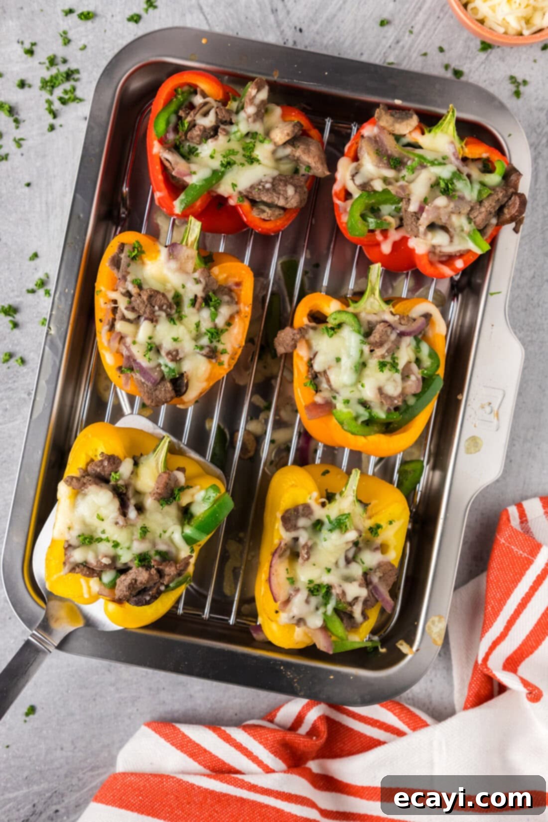 Loaded Philly Cheesesteak Peppers 2 Spatula picking up a Philly Cheesesteak Stuffed Pepper off a pan of Philly Cheesesteak Stuffed Peppers