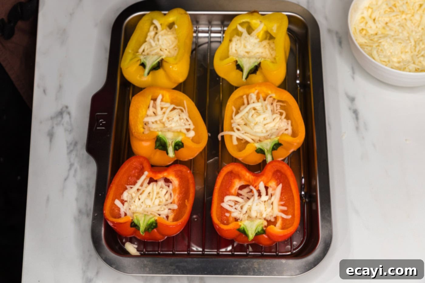 Loaded Philly Cheesesteak Peppers 6 halved bell peppers on a baking sheet with cheese