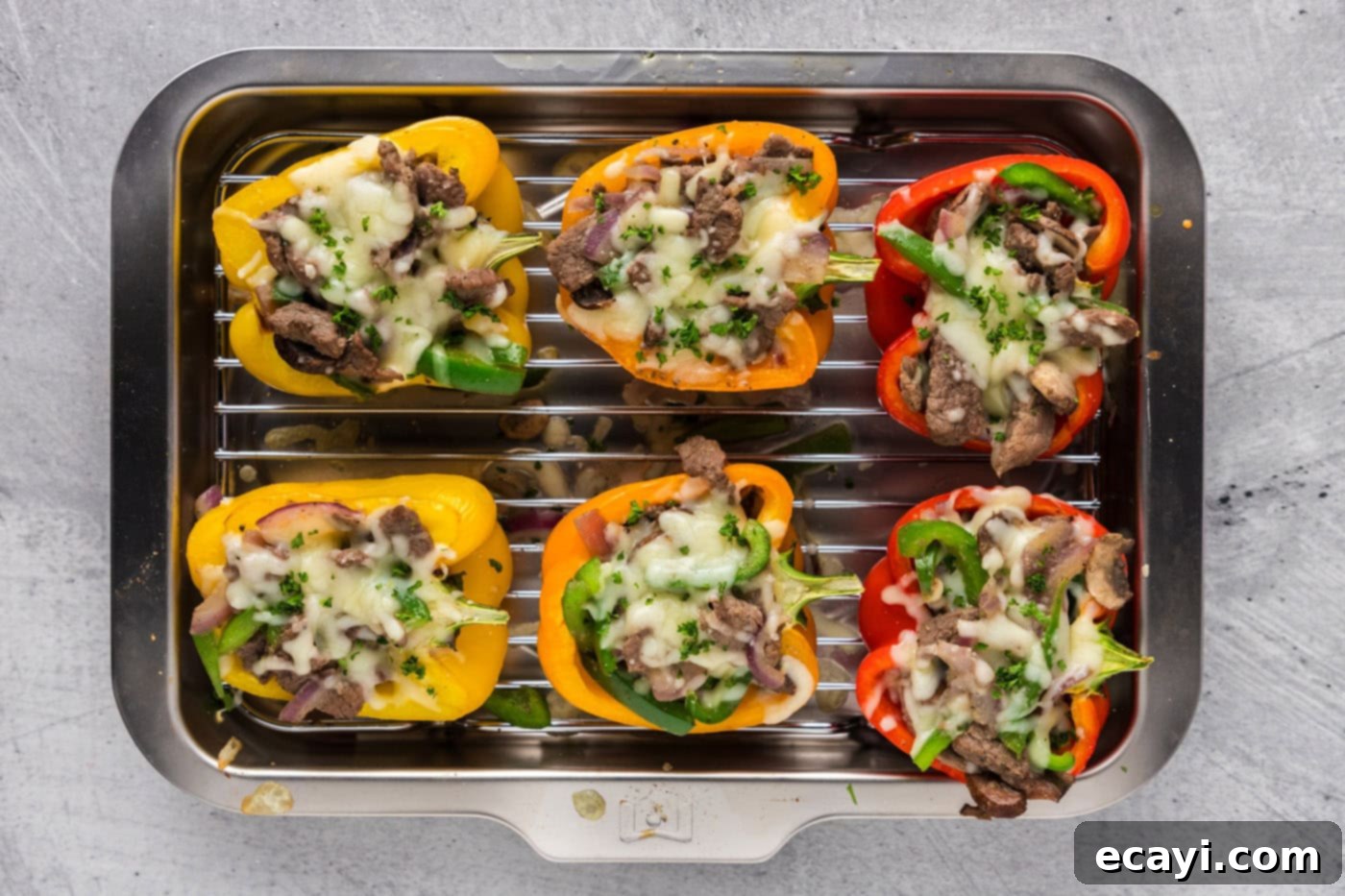 Loaded Philly Cheesesteak Peppers 8 baked overhead shot of philly cheesesteak stuffed peppers in a baking dish