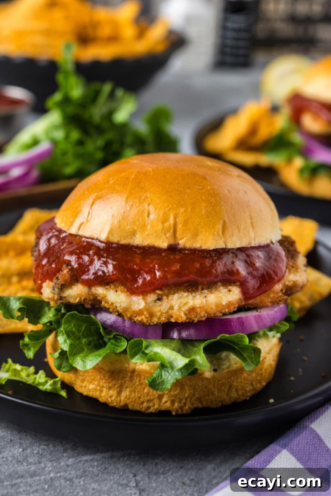 Zesty Shrimp Burger 2 Two golden-brown shrimp burgers, one held by hands, showcasing its crispy exterior and tender inside