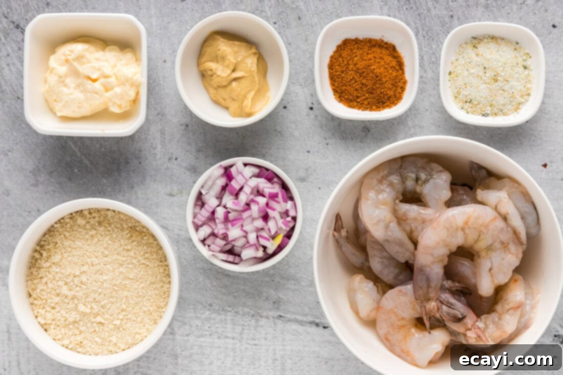 Zesty Shrimp Burger 4 A collection of ingredients laid out for making shrimp burgers, including shrimp, panko, butter, mustard, and spices.