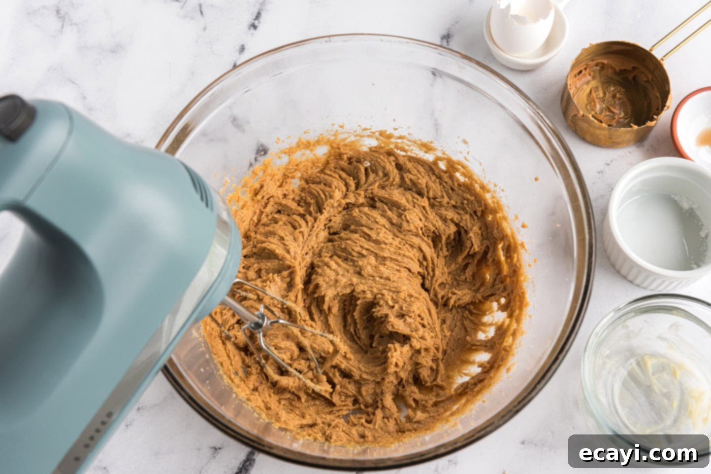 Reese's Peanut Butter Cup Stuffed Cookies 7 beating egg into peanut butter cookie dough in a bowl