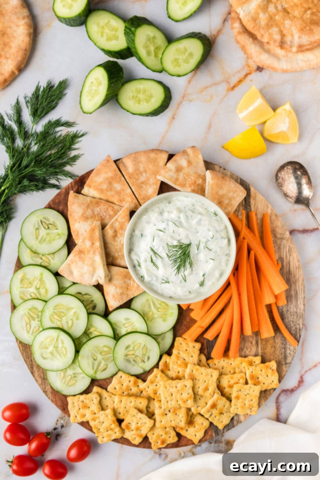 Classic Tzatziki Dip 2 Tzatziki Sauce in a bowl on a platter with pita bread, crackers, carrots and cucumbers