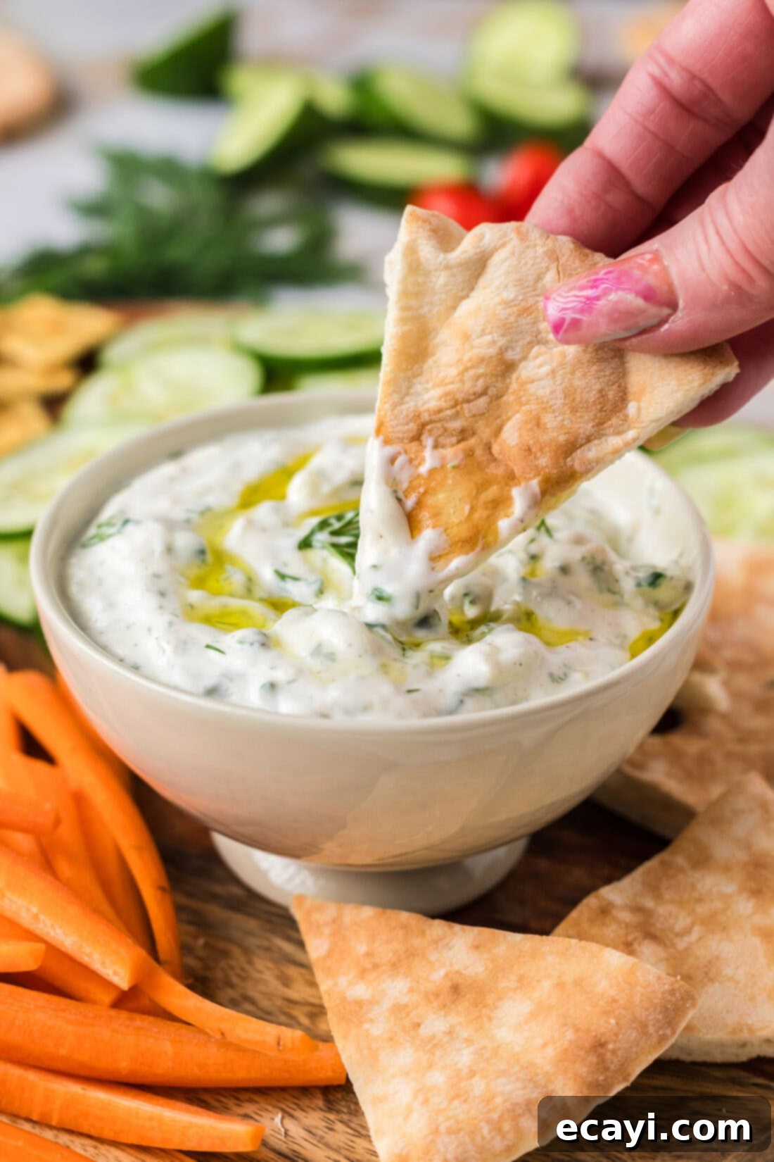 Classic Tzatziki Dip 3 Pita bread being dipped in Tzatziki Sauce