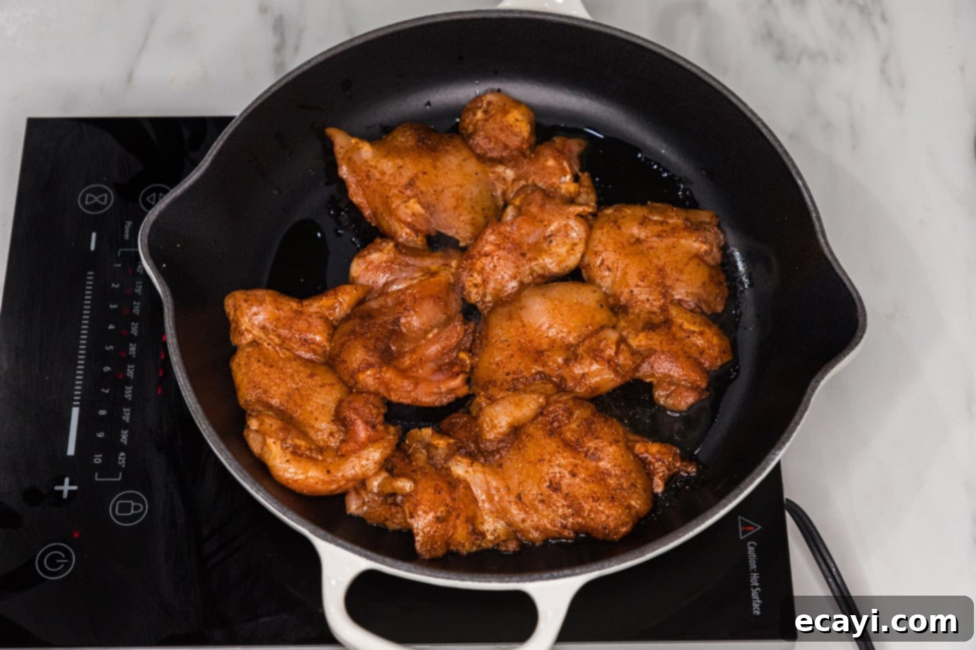 Authentic Chicken Shawarma 7 Skillet-cooked chicken shawarma pieces sizzling in a hot pan, showing the golden-brown crust developing on the chicken as it cooks.