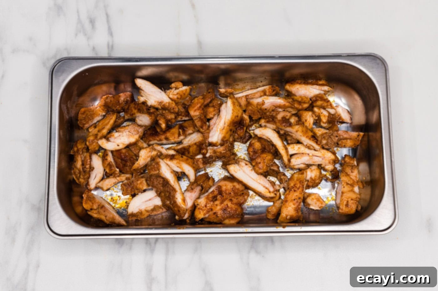 Authentic Chicken Shawarma 9 Sliced chicken shawarma strips in a pan, ready to be served or added to fresh pita wraps, showing the tender, seasoned meat.