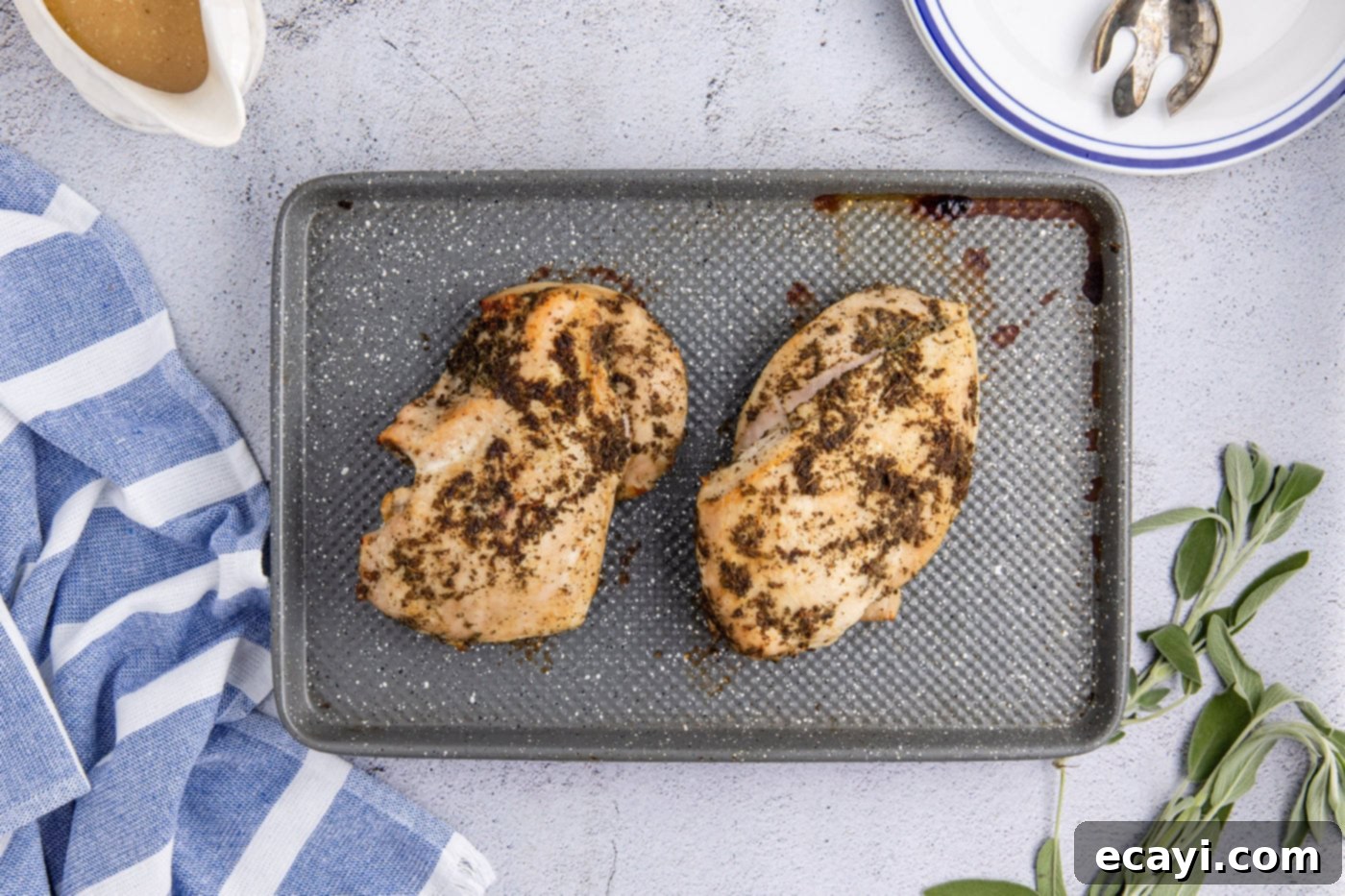 Perfectly Tender Crockpot Turkey Breast 14 Cooked turkey breasts resting on a baking sheet, preparing for the final broiling step to crisp the skin.