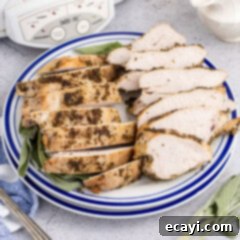 Perfectly Tender Crockpot Turkey Breast 16 sliced cooked turkey breast on a plate