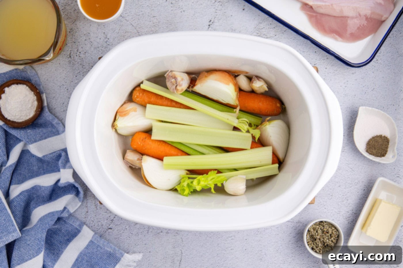 Perfectly Tender Crockpot Turkey Breast 5 Celery, onion, and carrots forming a bed in the bottom of a slow cooker.