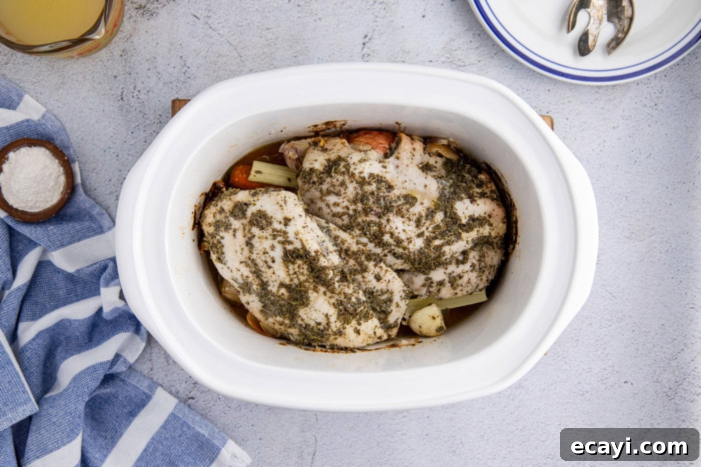 Perfectly Tender Crockpot Turkey Breast 10 A perfectly cooked turkey breast, golden brown and moist, nestled in the slow cooker crock with cooked vegetables.