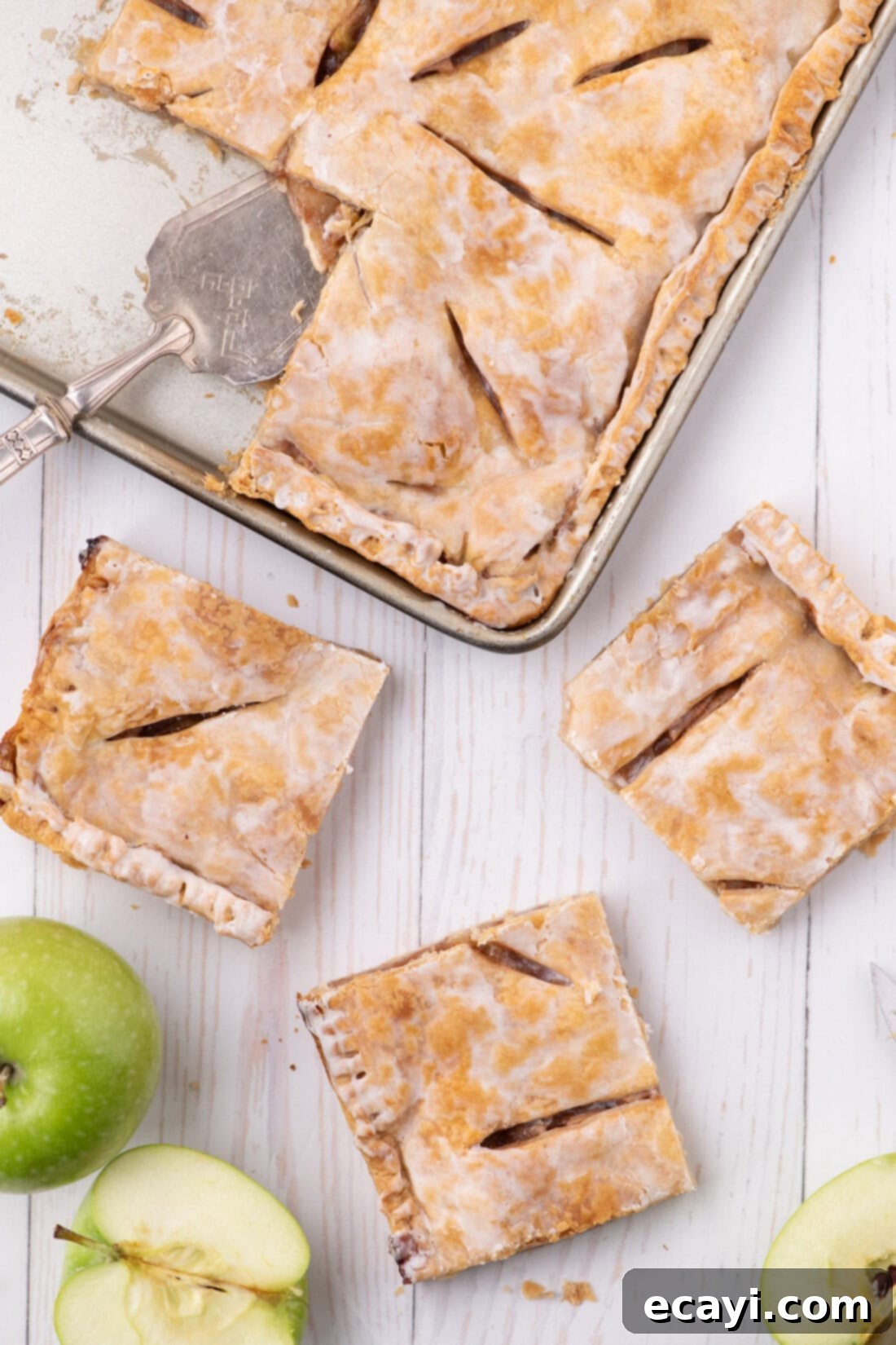 Sheet Pan Apple Pie 2 Three slices of Apple Slab Pie resting on a table with the pan in the background