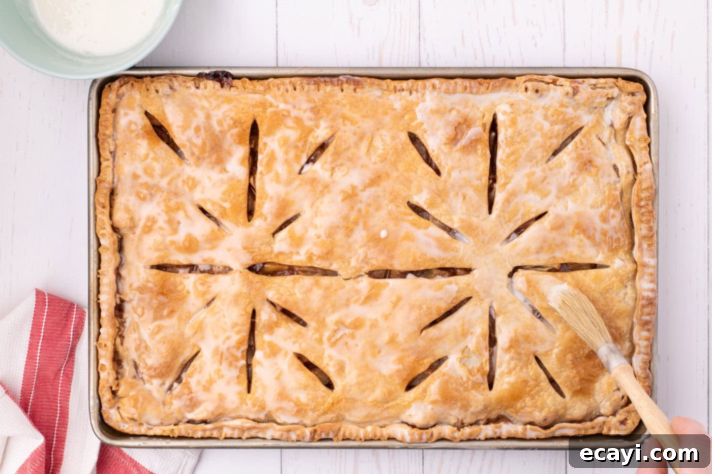 Sheet Pan Apple Pie 15 apple slab pie topped with powdered sugar glaze