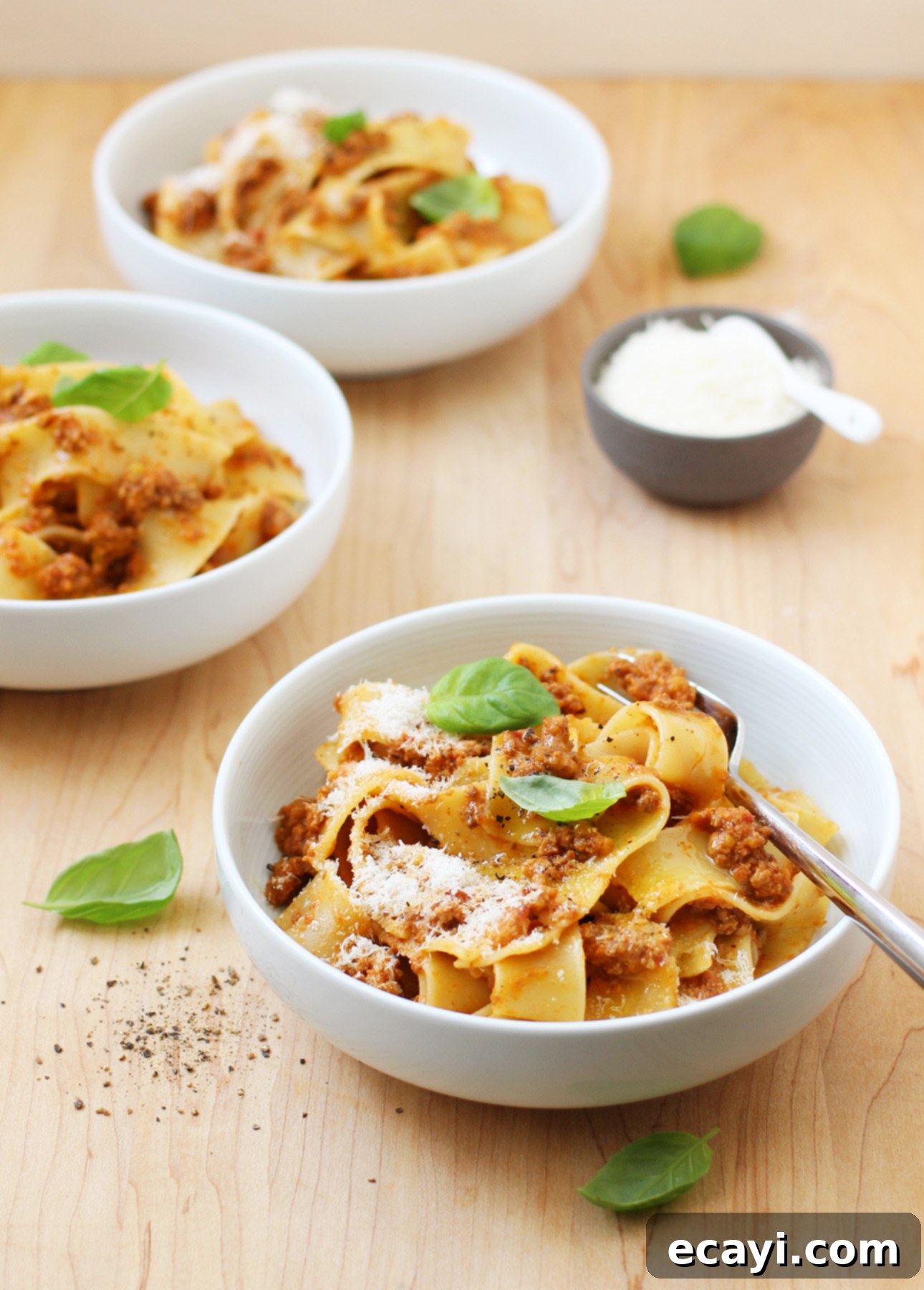 Master Authentic Bolognese Sauce 17 Serving bowls of Pappardelle al Ragù Bolognese, featuring wide pasta generously coated with authentic Italian Bolognese Sauce, garnished with basil and Parmigiano-Reggiano