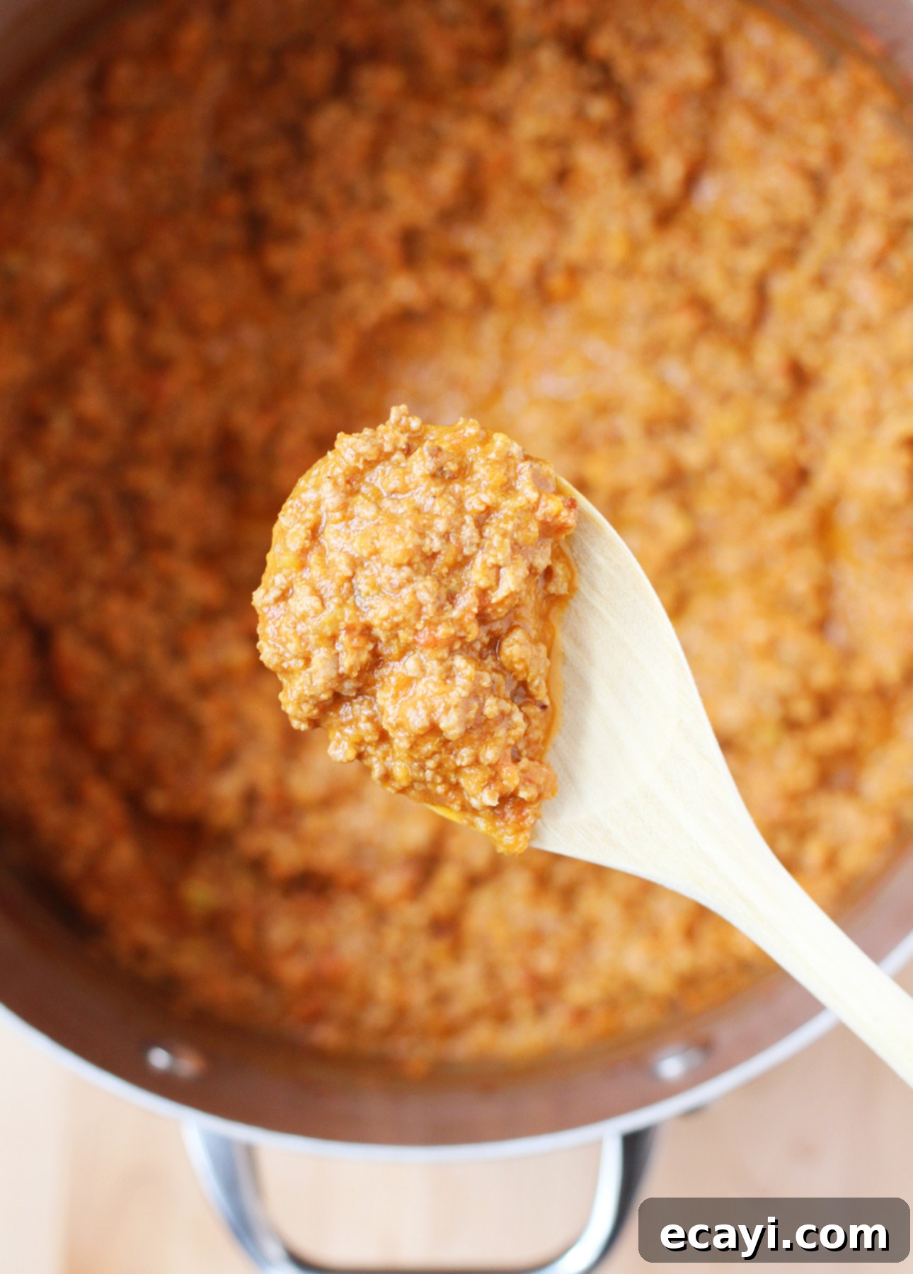 Master Authentic Bolognese Sauce 6 A scoop of rich and creamy, freshly made authentic Italian Bolognese Sauce, showcasing its texture