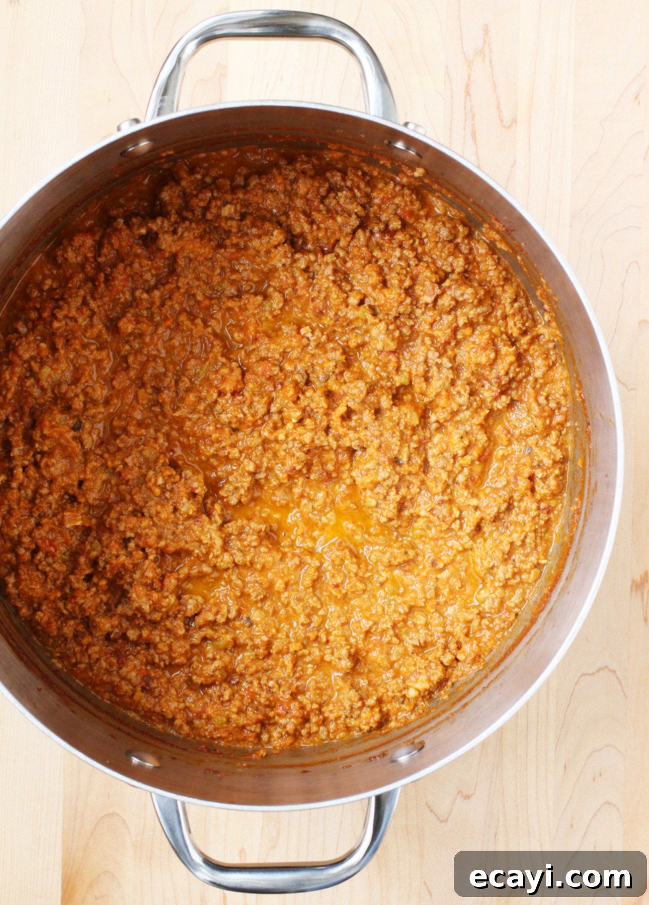 Master Authentic Bolognese Sauce 8 A large pot of freshly made, simmering authentic Bolognese sauce on the stovetop
