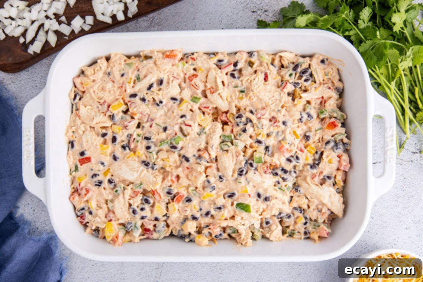 Cheesy Chicken Taco Casserole 8 chicken taco casserole mixture in a baking dish, ready for the oven.