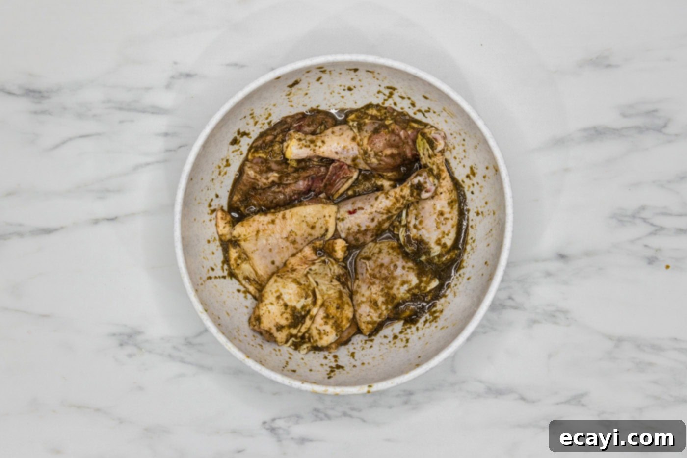 Caribbean Jerk Chicken 6 chicken in a large bowl coated in marinade
