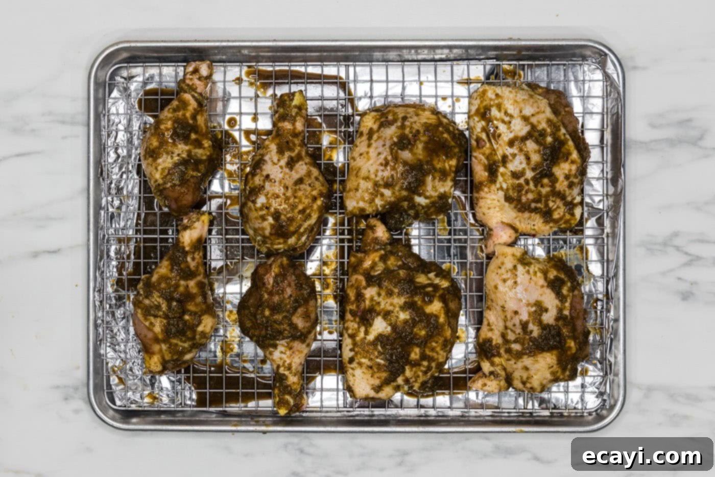 Caribbean Jerk Chicken 8 marinated jerk chicken on a wire rack over a baking sheet