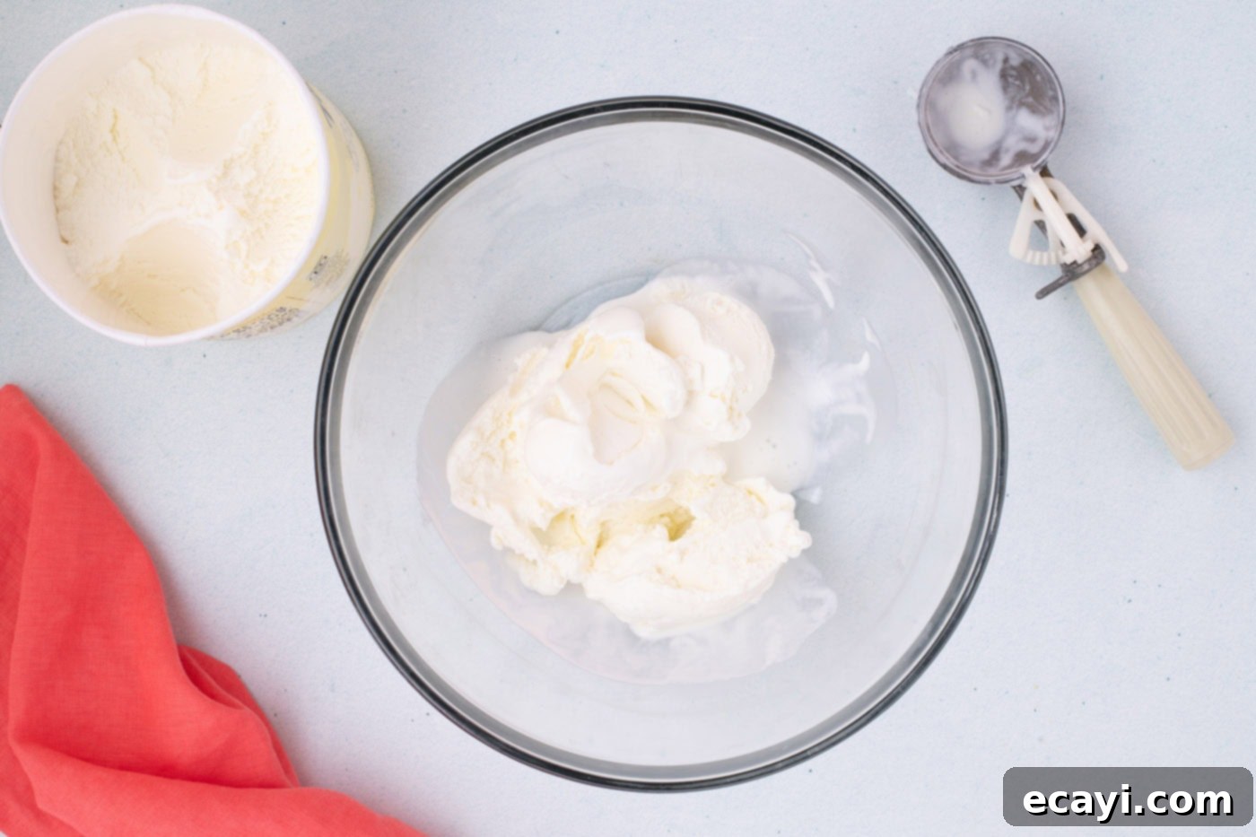 2-Ingredient Ice Cream Bread 5 A bowl filled with softened vanilla ice cream, ready for the next step of the ice cream bread recipe.