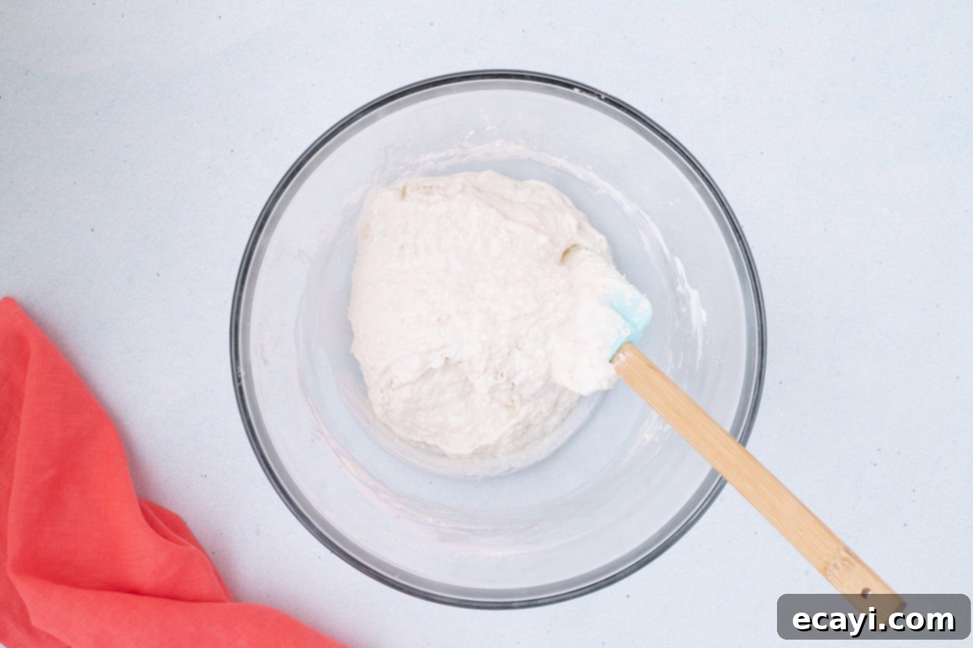 2-Ingredient Ice Cream Bread 7 Vanilla ice cream and self-rising flour gently mixed in a bowl, showing a slightly lumpy but combined batter.