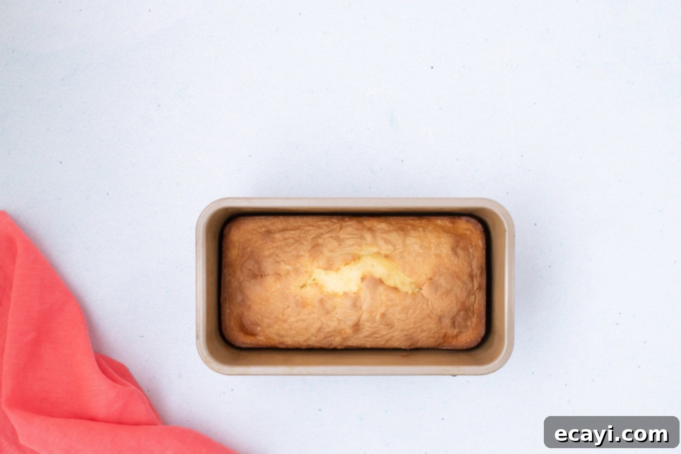 2-Ingredient Ice Cream Bread 9 A golden-brown baked ice cream bread loaf still in its pan, fresh from the oven.
