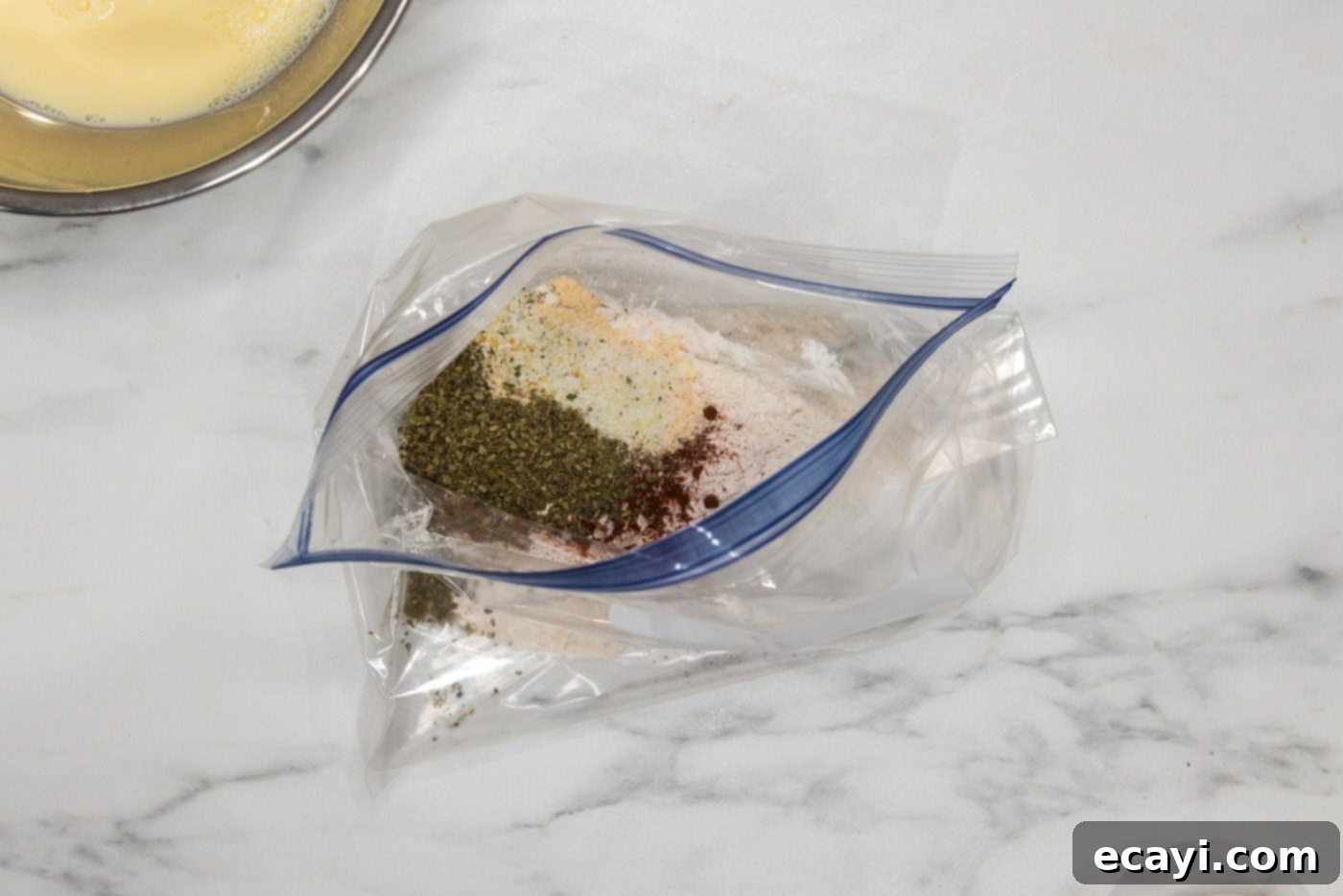 Golden Fried Florets 7 A large gallon-sized zipper bag containing flour and various seasonings like paprika, oregano, onion powder, garlic salt, and parmesan cheese, ready to be shaken