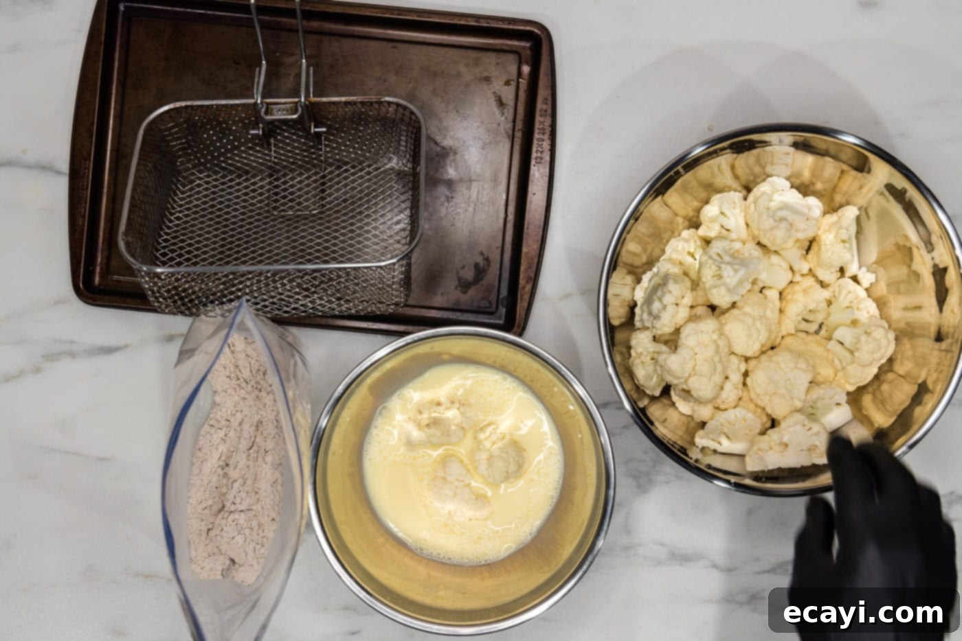 Golden Fried Florets 8 Cauliflower florets coated in the egg and milk mixture, ready for the next step of dredging