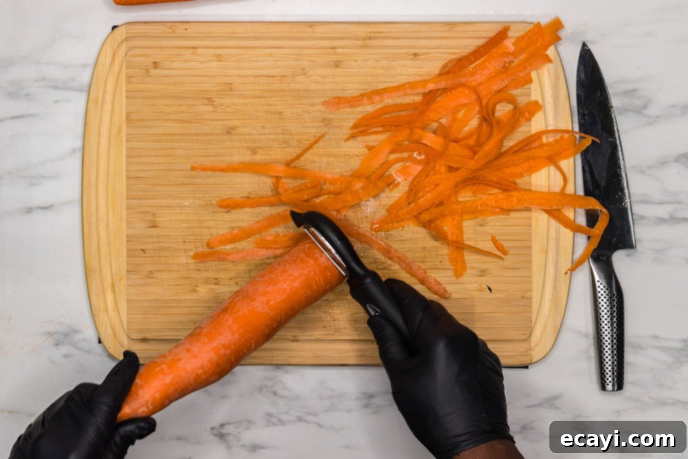 Golden Carrot Crush 5 peeling carrot with a vegetable peeler