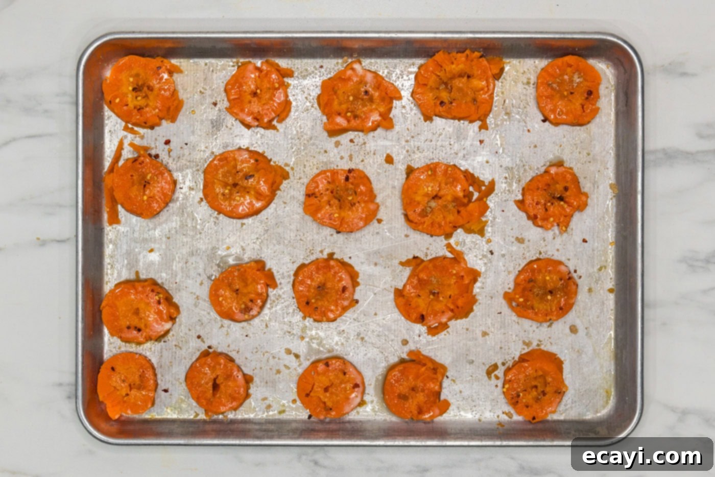 Golden Carrot Crush 10 seasoned smashed carrots on a baking sheet