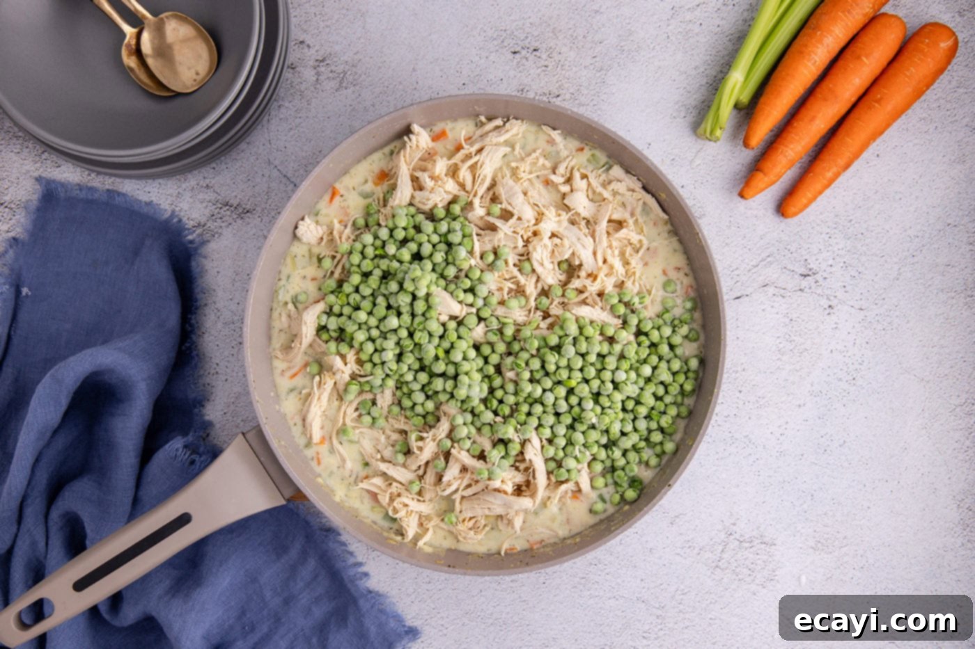 Hearty Chicken Pot Pie Casserole 9 frozen peas added to chicken pot pie mixture in a skillet