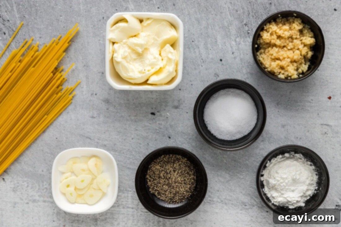 Irresistible Garlic Butter Pasta 4 All the fresh ingredients laid out for making garlic butter pasta, including butter, fresh garlic, spaghetti, and seasonings.