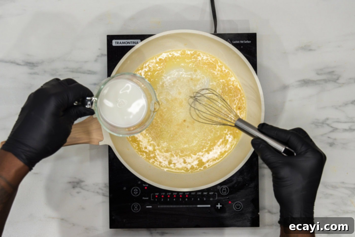 Irresistible Garlic Butter Pasta 5 Whisking a cornstarch and water mixture into sautéed minced garlic and melted butter in a skillet to create a smooth sauce base.