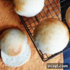 Soft and Fluffy Homemade Burger Buns 11 An overhead photo of homemade hamburger buns on a cooling rack.