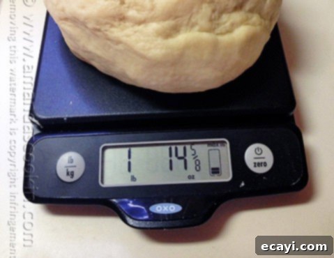 Soft and Fluffy Homemade Burger Buns 6 A reliable OXO kitchen scale showing a precise measurement, essential for consistent baking results.