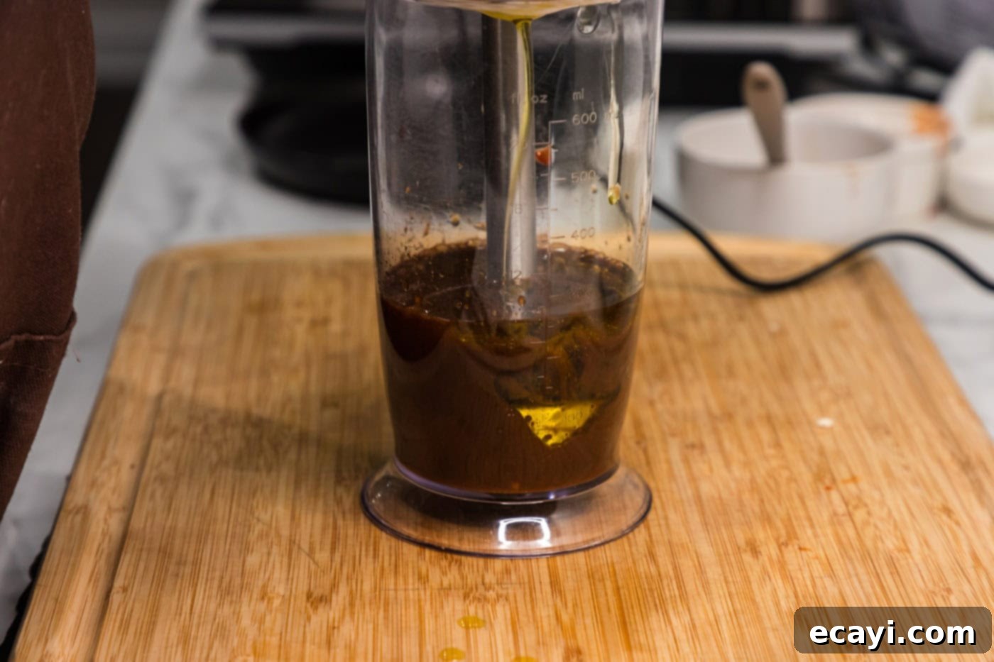 Fiery Tofu 7 tofu marinade ingredients being blended in an immersion blender