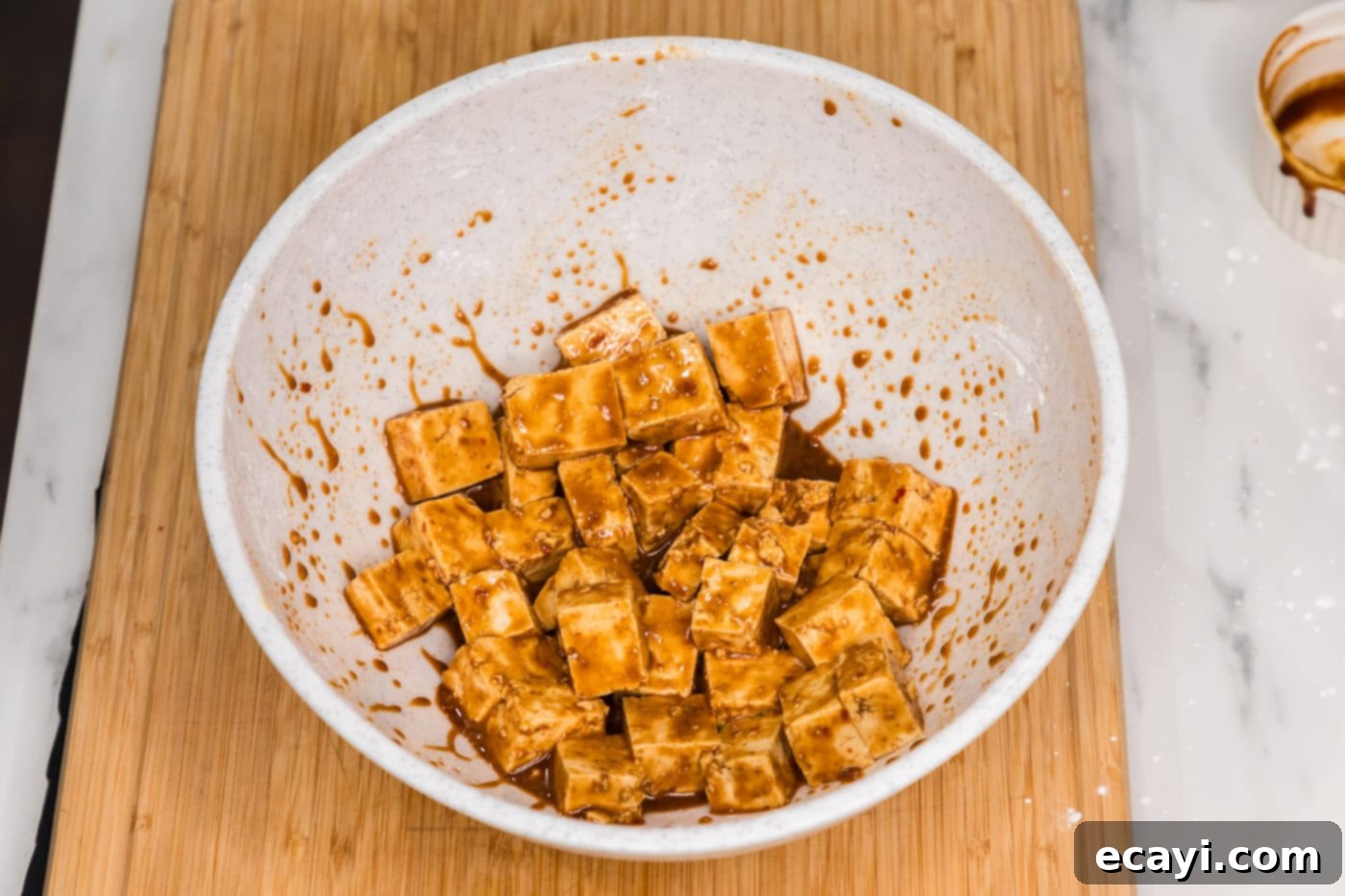 Fiery Tofu 8 marinated tofu in a bowl, soaking up the spicy sauce