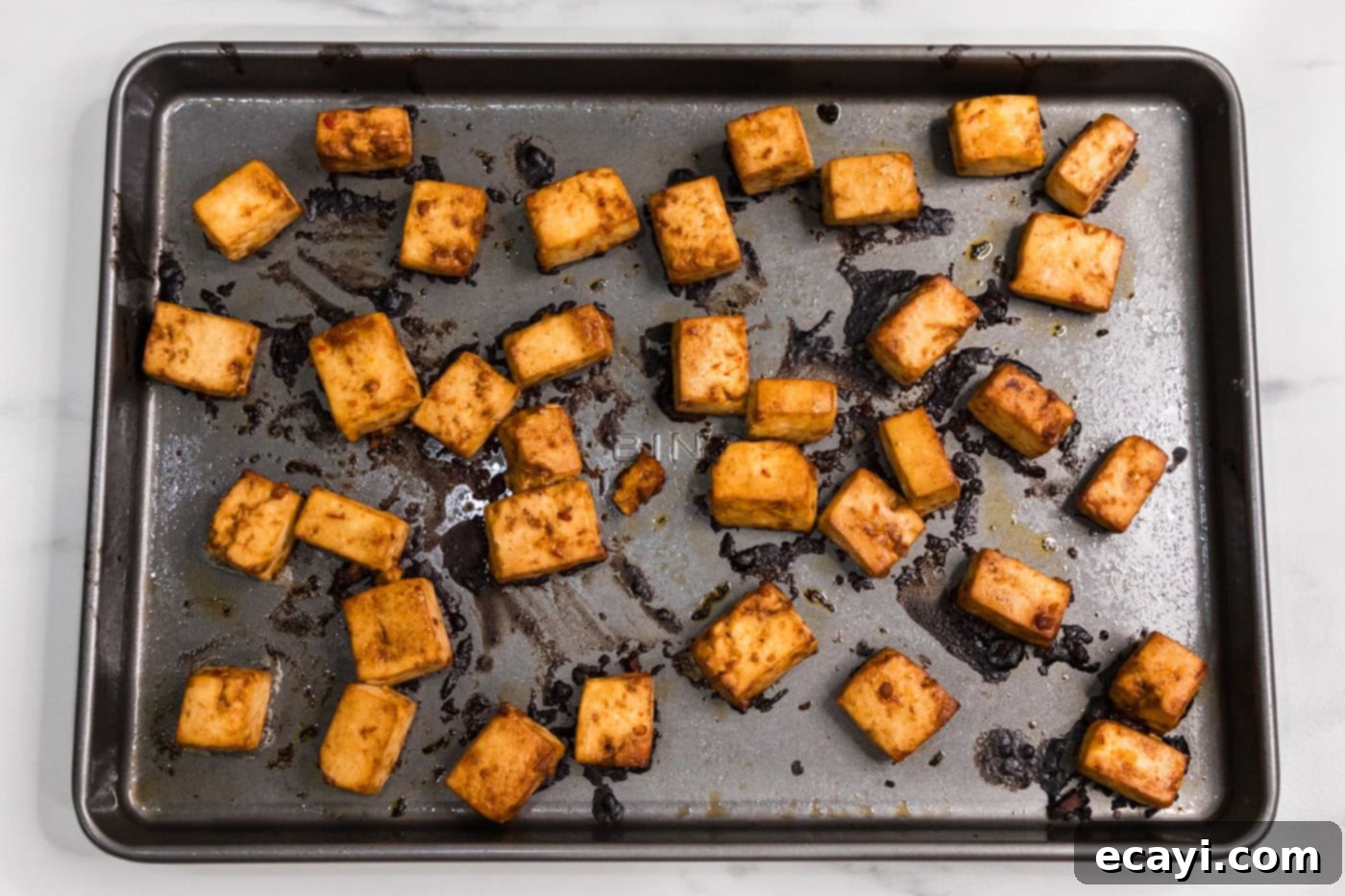 Fiery Tofu 10 baked spicy tofu on a baking sheet, golden and crispy