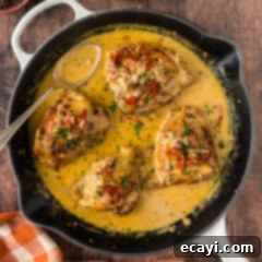 Crispy Skillet Chicken Thighs 14 Skillet Chicken Thighs in a skillet with a spoon to the side