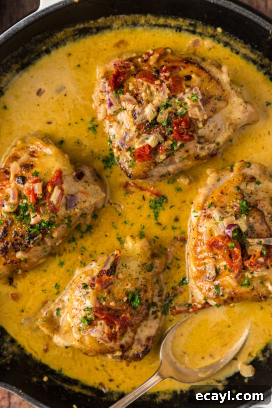 Crispy Skillet Chicken Thighs 3 Close up photo of Skillet Chicken Thighs simmering in a creamy sauce