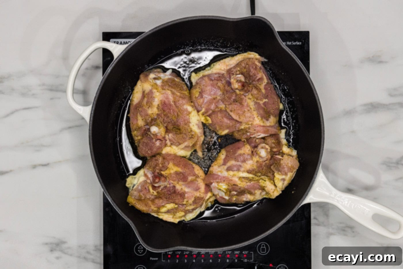 Crispy Skillet Chicken Thighs 6 pan searing chicken thighs in a skillet with oil