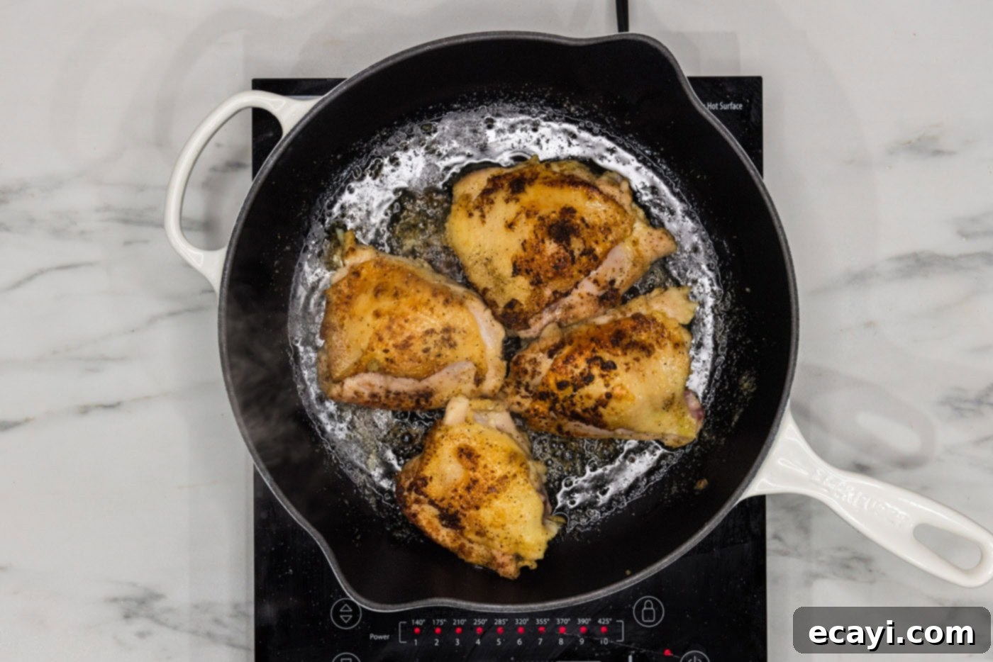 Crispy Skillet Chicken Thighs 7 browned chicken thighs in a skillet