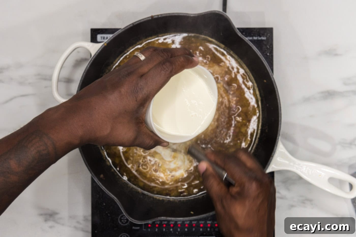 Crispy Skillet Chicken Thighs 10 whisking heavy cream into skillet with onions and garlic