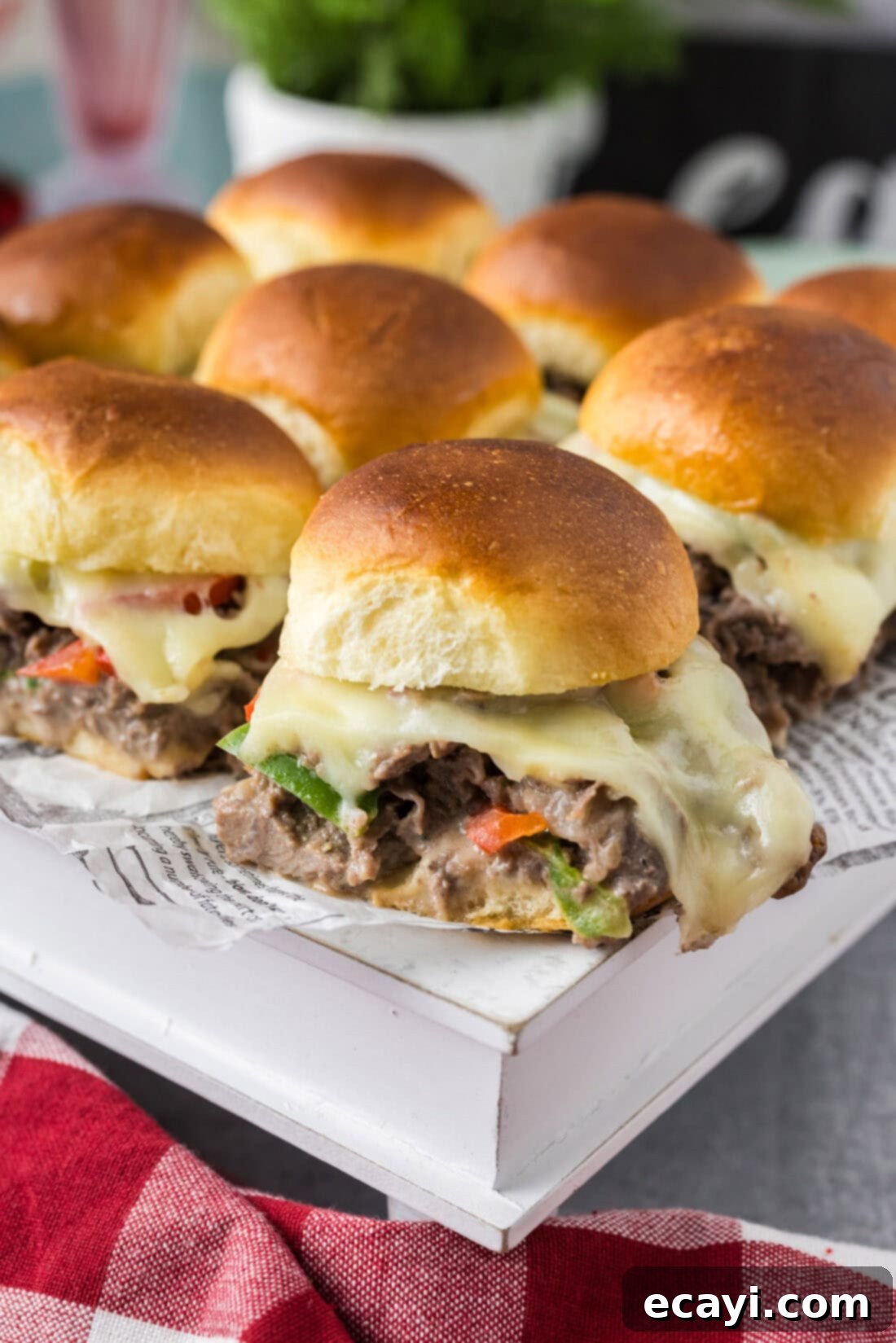 Cheesesteak Slider Bites 3 Philly Cheesesteak Sliders on a white serving board