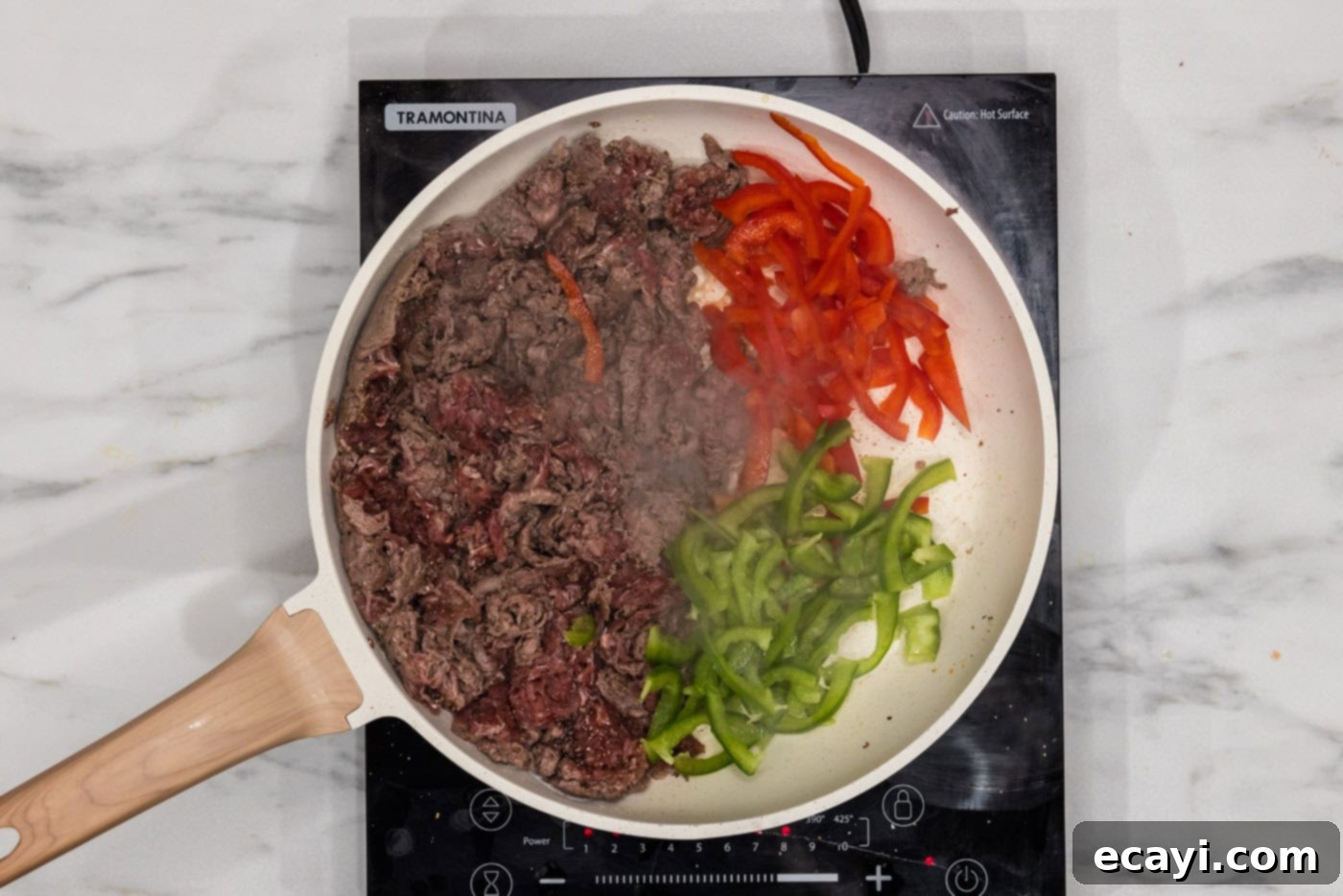 Cheesesteak Slider Bites 6 bell peppers in a skillet with shaved beef