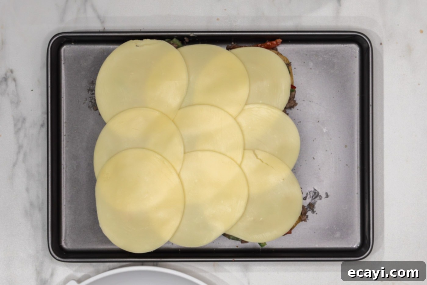 Cheesesteak Slider Bites 10 provolone cheese on top of beef sliders