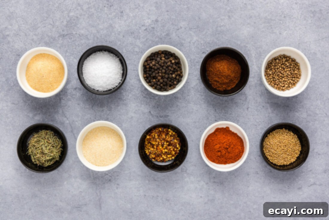 Crafting Your Own Montreal Steakhouse Blend 4 Individual ingredients for Homemade Montreal Steak Seasoning laid out on a surface before blending.